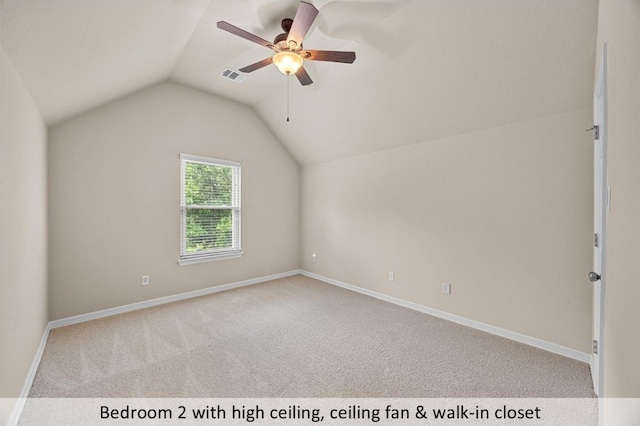 additional living space featuring ceiling fan, visible vents, carpet, baseboards, and lofted ceiling