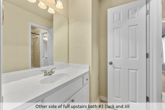 full bath featuring baseboards, a notable chandelier, and vanity
