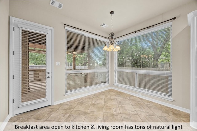 unfurnished dining area with light tile patterned flooring, visible vents, a chandelier, and baseboards