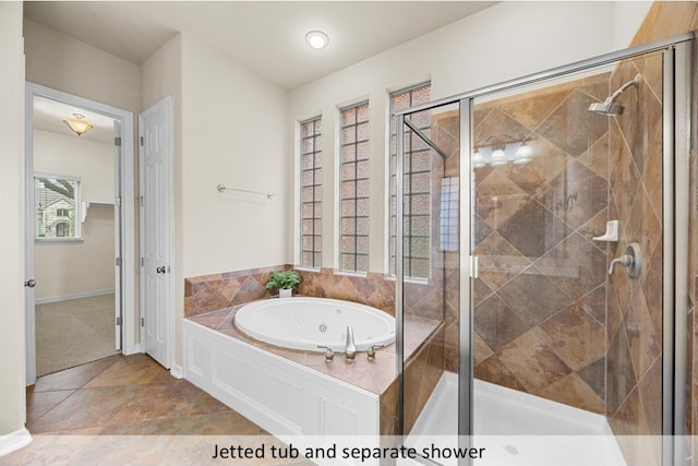 full bath with a jetted tub, a shower stall, and baseboards