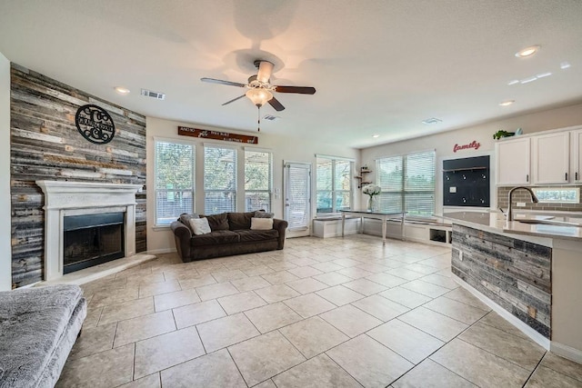 living room featuring visible vents, ceiling fan, recessed lighting, a fireplace, and light tile patterned flooring