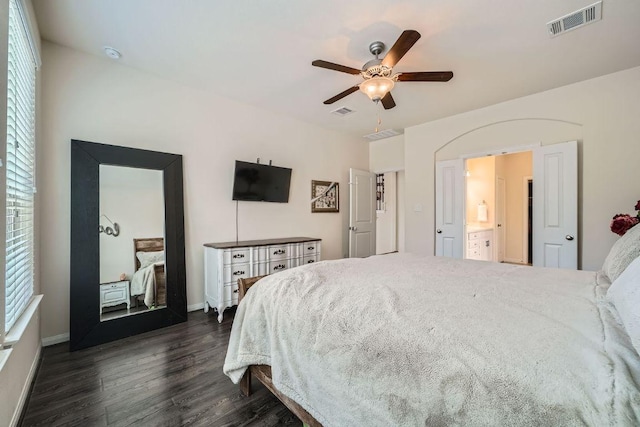 bedroom with visible vents, multiple windows, and dark wood-type flooring