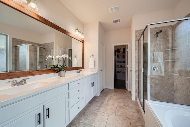 165 Crescent Heights Dr, Georgetown, TX 78628 - full bathroom featuring a stall shower, double vanity, a garden tub, and tile patterned floors