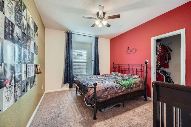 carpeted bedroom featuring a textured ceiling, baseboards, and ceiling fan