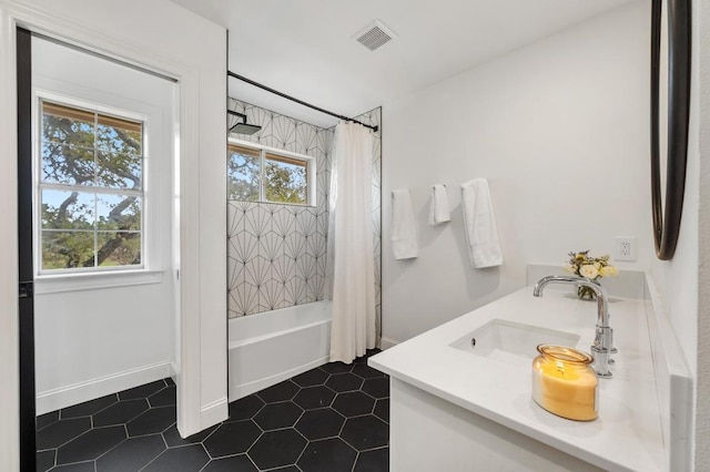 bathroom with visible vents, double vanity, a sink, shower / bath combination with curtain, and tile patterned floors