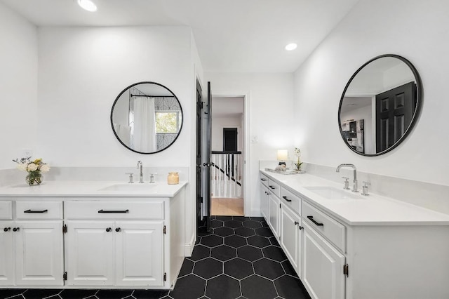 bathroom featuring tile patterned flooring, two vanities, recessed lighting, and a sink