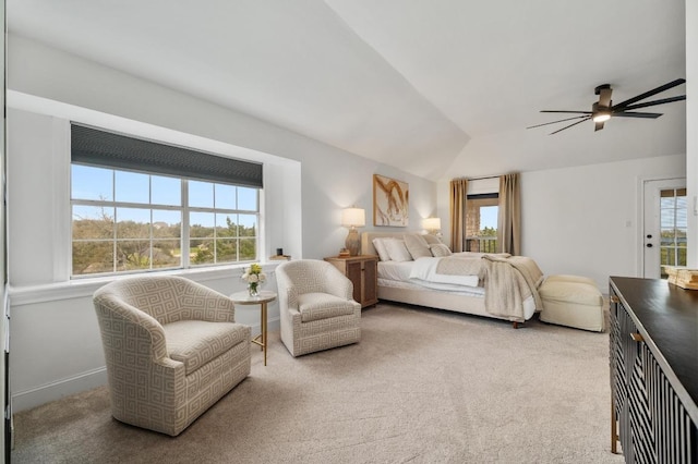 carpeted bedroom with multiple windows, ceiling fan, and vaulted ceiling