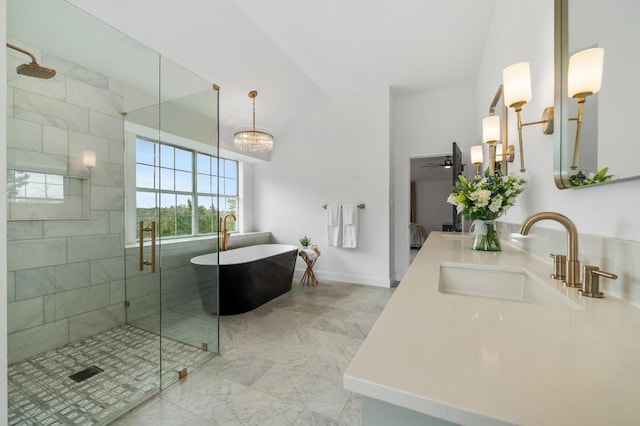 full bath with baseboards, double vanity, a freestanding bath, a sink, and a shower stall