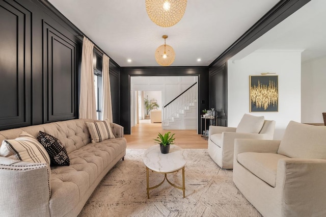 living area featuring recessed lighting, stairway, light wood-style floors, and ornamental molding