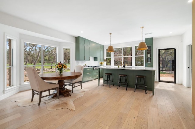 dining area with recessed lighting and light wood finished floors