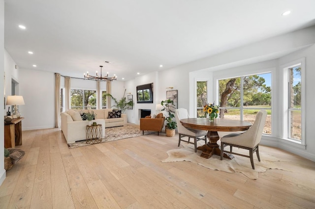 dining area featuring a notable chandelier, recessed lighting, light wood-type flooring, and a wealth of natural light