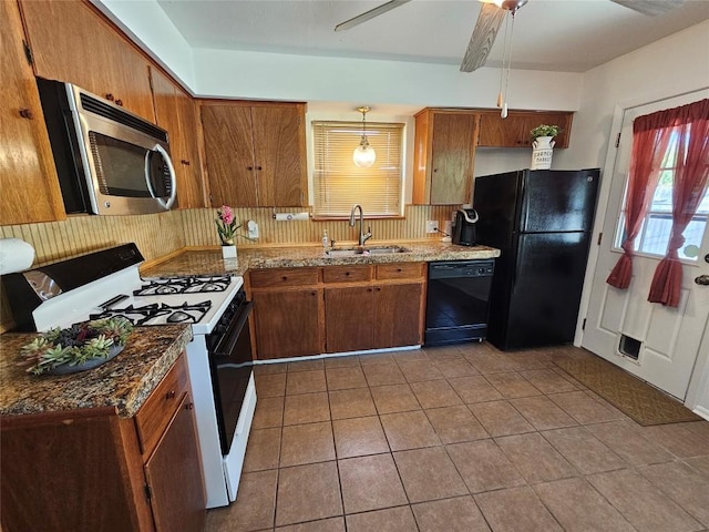 kitchen with light tile patterned flooring, a sink, backsplash, and black appliances