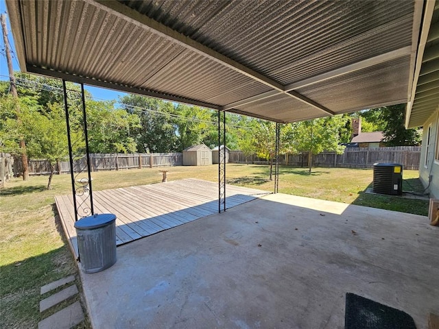 view of patio featuring central AC, an outdoor structure, a fenced backyard, and a storage unit