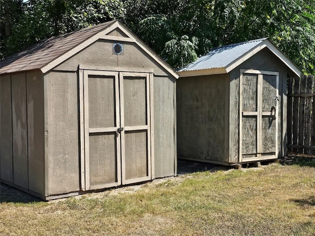 view of shed featuring fence