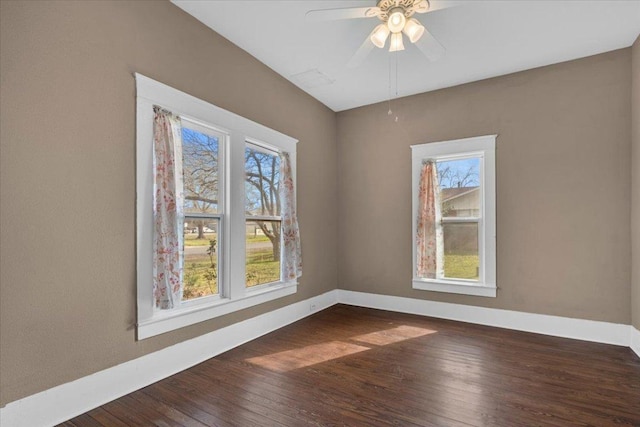 spare room featuring ceiling fan, wood finished floors, and baseboards