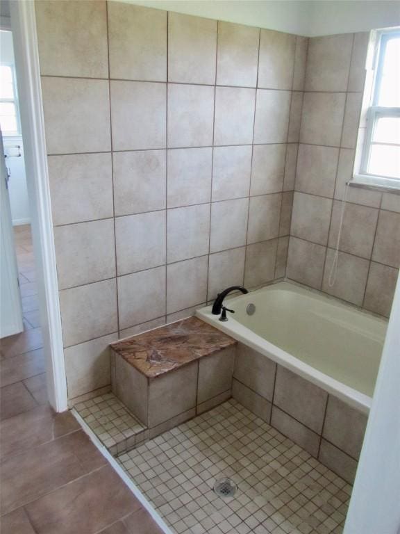 full bath with tiled tub, tile patterned flooring, and tiled shower