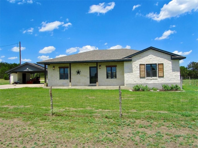 ranch-style house featuring stone siding, a shingled roof, and a front yard