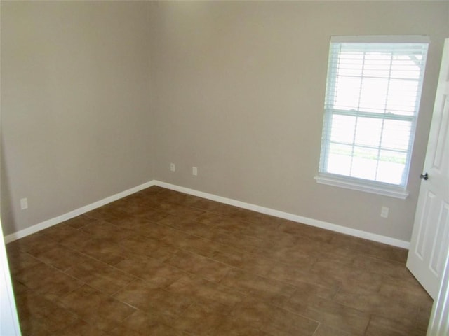 spare room featuring baseboards