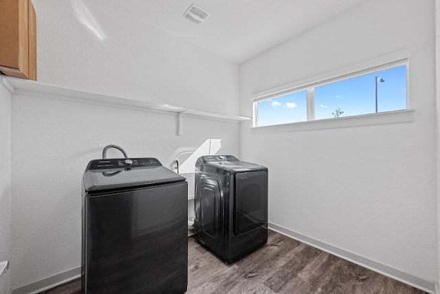 10410 Fulton Ave, Austin, TX 78754 - washroom featuring cabinet space, wood finished floors, washing machine and dryer, and baseboards
