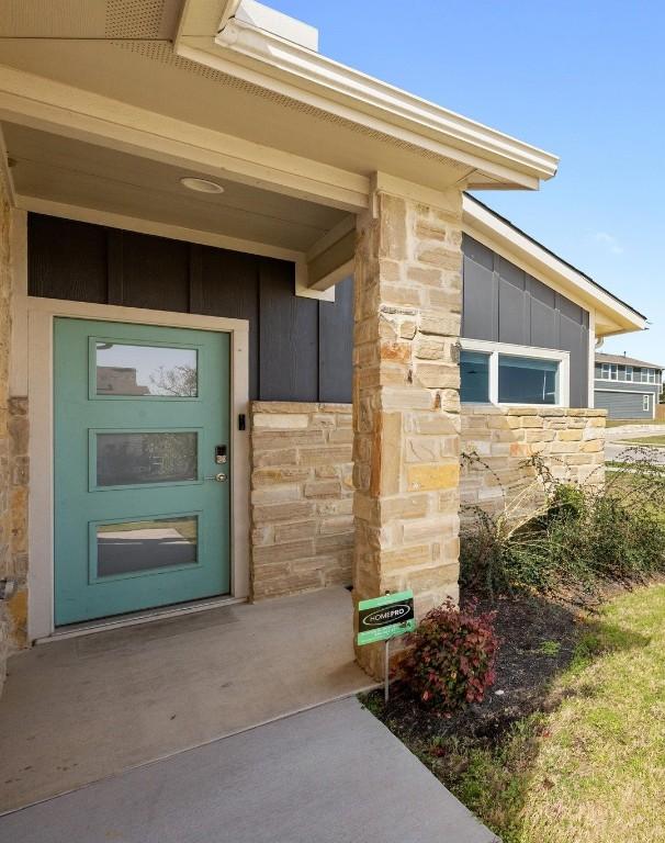 10410 Fulton Ave, Austin, TX 78754 - view of exterior entry featuring board and batten siding and stone siding
