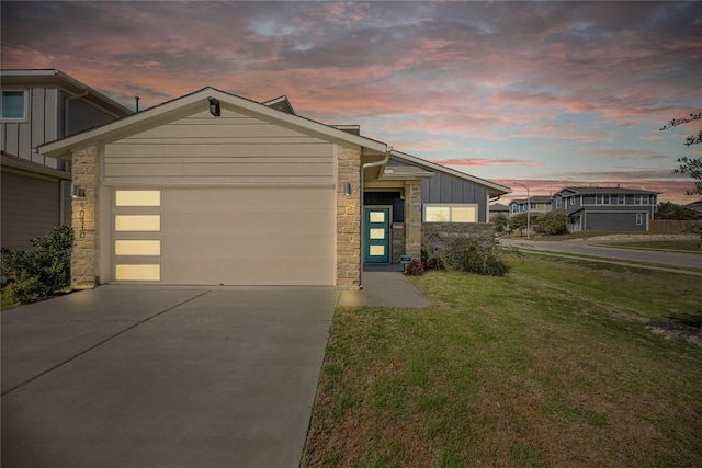 10410 Fulton Ave, Austin, TX 78754 - view of front of home featuring board and batten siding, stone siding, a garage, and concrete driveway