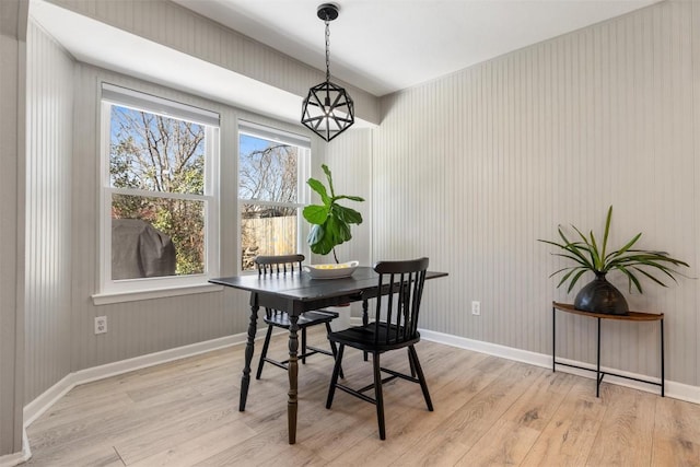 dining space featuring baseboards and light wood-style floors