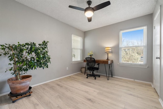 office space featuring a textured ceiling, wood finished floors, a ceiling fan, and baseboards