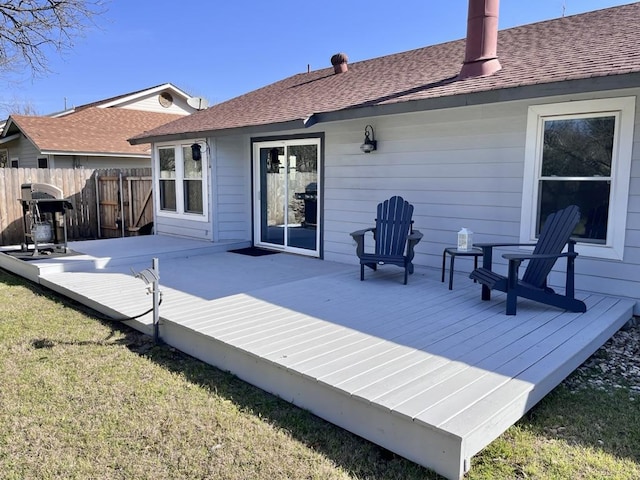 deck with a yard, fence, and grilling area