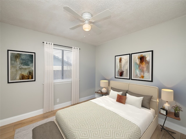 bedroom featuring light wood-type flooring, ceiling fan, a textured ceiling, and baseboards