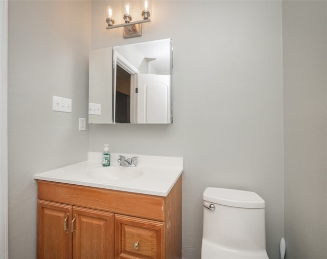 bathroom featuring toilet and vanity