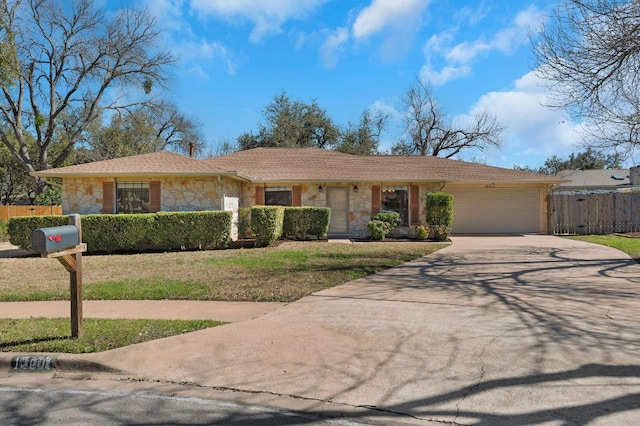 single story home featuring concrete driveway, an attached garage, fence, and stone siding