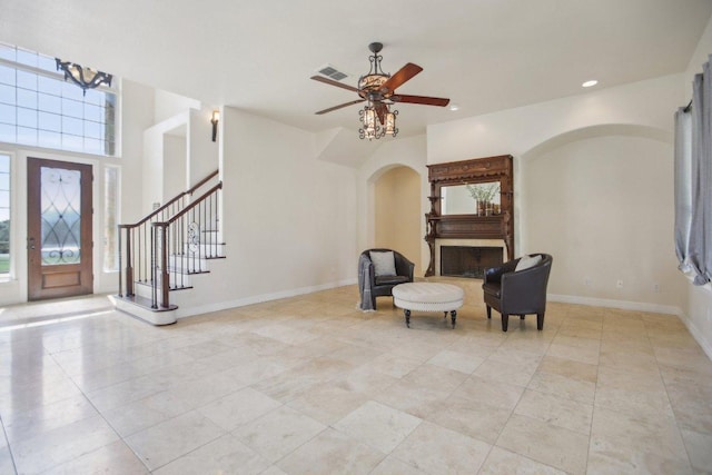 foyer with recessed lighting, stairway, light tile patterned floors, visible vents, and arched walkways