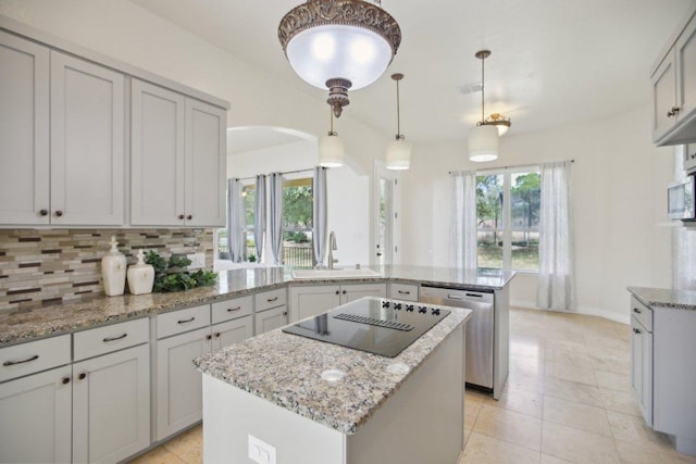 kitchen featuring a sink, a peninsula, a kitchen island, stainless steel dishwasher, and arched walkways