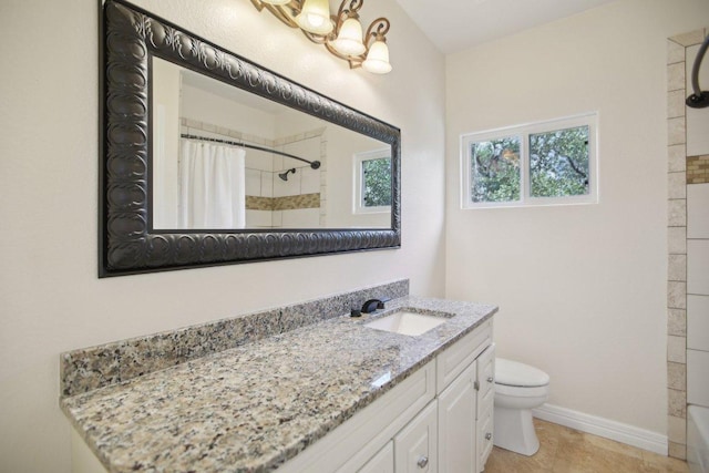 bathroom featuring vanity, toilet, a shower with curtain, and baseboards