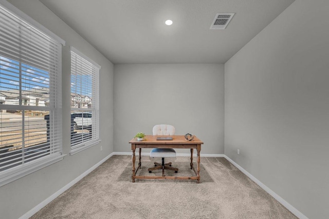 home office featuring carpet floors, visible vents, and baseboards