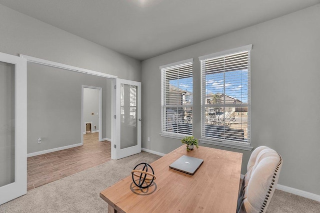 dining room featuring french doors, carpet flooring, and baseboards