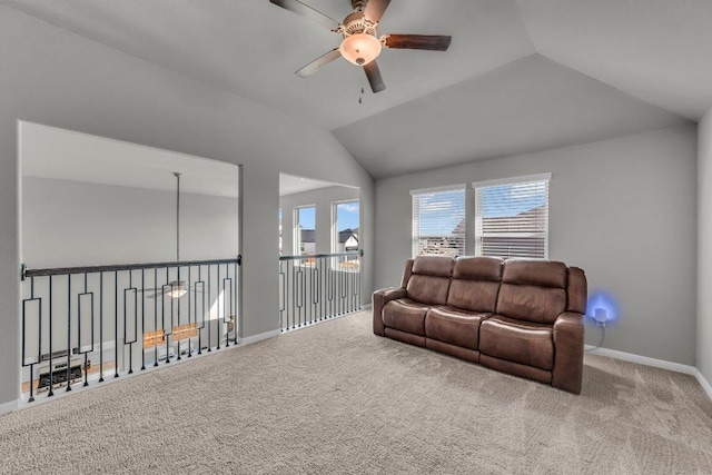 carpeted living room featuring a ceiling fan, lofted ceiling, and baseboards