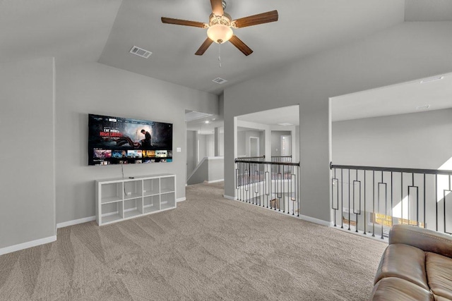 living area with baseboards, visible vents, and carpet flooring