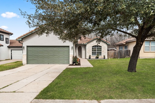 view of front of home featuring an attached garage, fence, stone siding, driveway, and a front yard