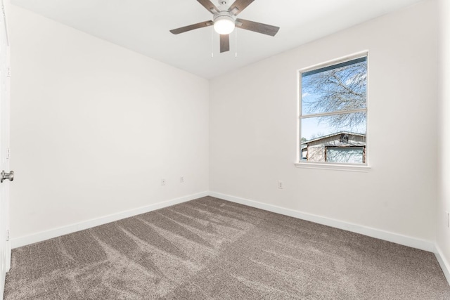 spare room featuring carpet, a ceiling fan, and baseboards