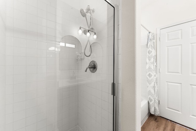 5604 Toscana Ave, Austin, TX 78724 - bathroom featuring wood finished floors and tiled shower / bath combo