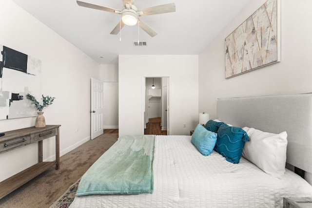 bedroom featuring carpet floors, visible vents, a spacious closet, ceiling fan, and baseboards