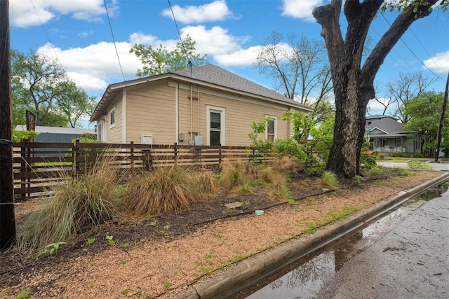 view of side of home with fence