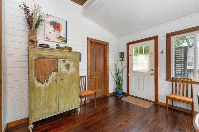 2300 Willow St, Austin, TX 78702 - foyer entrance featuring vaulted ceiling, dark wood-style floors, wooden walls, and ornamental molding