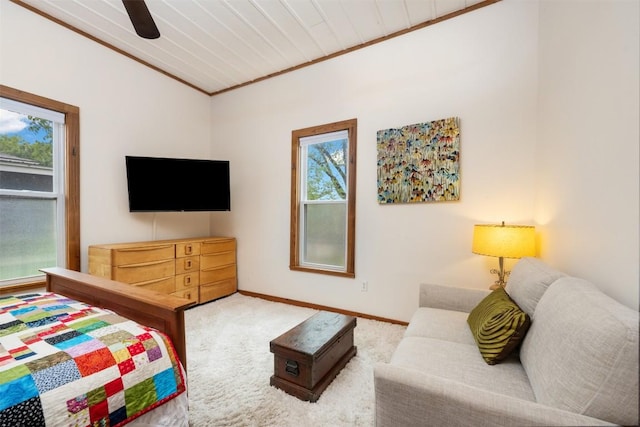 bedroom with crown molding, carpet flooring, a ceiling fan, and baseboards