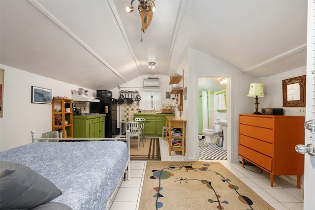 bedroom with light tile patterned floors, a wall mounted air conditioner, freestanding refrigerator, and lofted ceiling