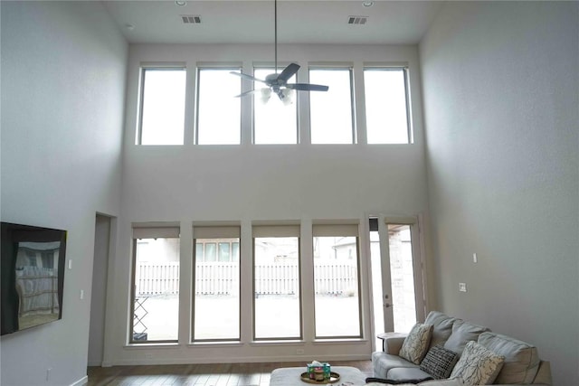 living room with a healthy amount of sunlight, visible vents, and wood finished floors