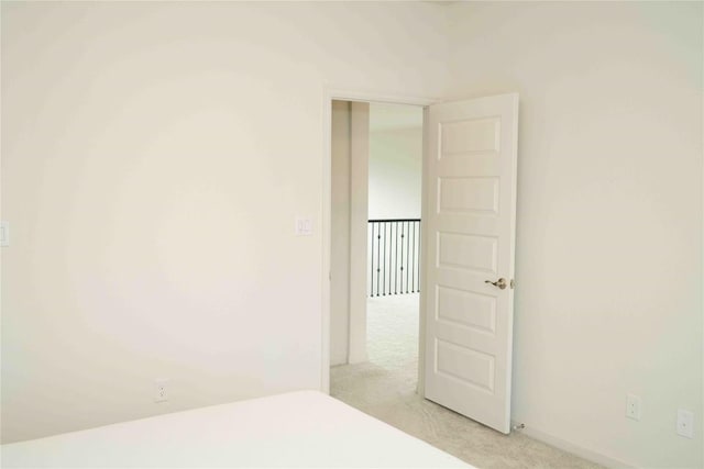 unfurnished bedroom with light colored carpet