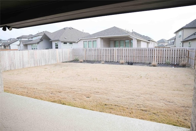 view of yard featuring a residential view and a fenced backyard