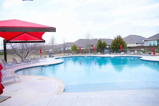 pool featuring fence and a patio